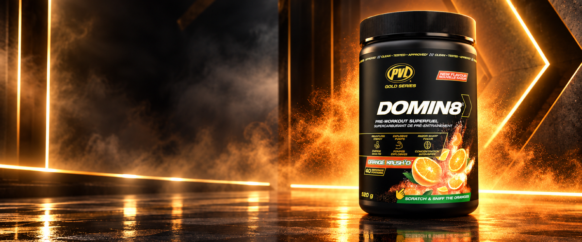 PVL DOMIN8 pre-workout in an orange performance studio